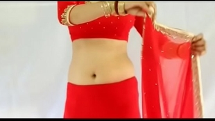 Super sexy lady dressed in a crimson sari and showing off her tits and back